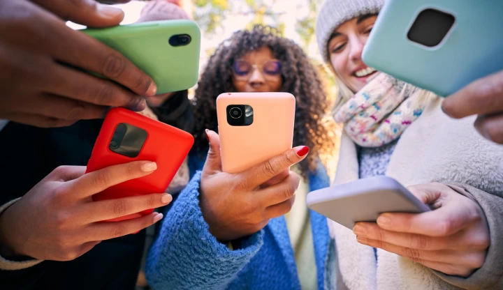 A group of people holding smartphones